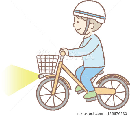 A boy wearing a helmet and riding a bicycle with lights on 126676380