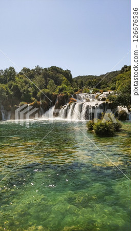 Waterfalls flowing into green lake in krka national park, croatia Waterfalls flowing into green lake in krka national park, croatia 126676586