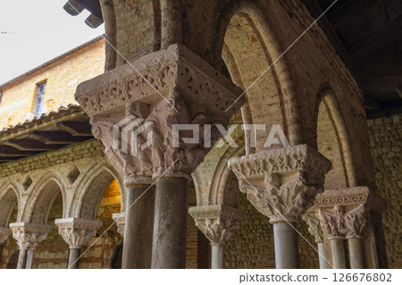 Sculpted capitals supporting romanesque arches in Moissac Abbey cloister, France 126676802