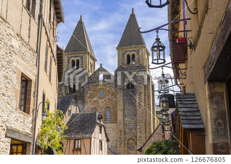 Sainte Foy Abbey rising above traditional houses in Conques en Rouergue, France Sainte Foy Abbey rising above traditional houses in Conques en Rouergue, France 126676805