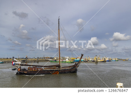 Traditional dutch sailing ship navigating Lauwersoog harbor in Groningen, Netherlands Traditional dutch sailing ship navigating Lauwersoog harbor in Groningen, Netherlands 126676847