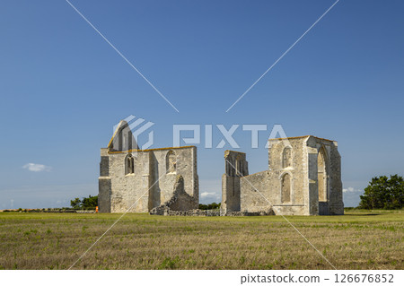 Ruins of the Abbey of Notre Dame de Re in La Flotte, France, standing in a field under a blue sky 126676852