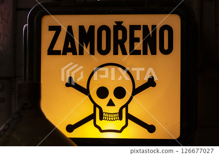 Contaminated area warning sign with skull and crossbones, illuminated in the dark Contaminated area warning sign with skull and crossbones, illuminated in the dark 126677027