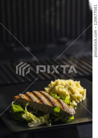tuna fish steak with couscous and salad 126677081