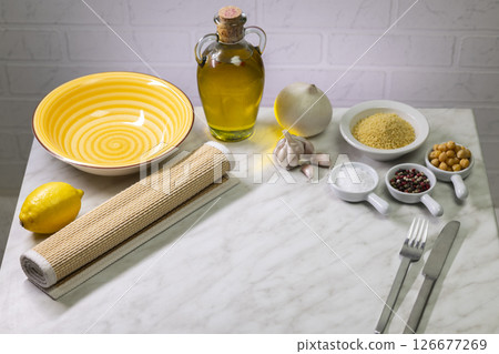 Preparing vegetarian couscous with chickpeas, lemon, garlic and onion 126677269