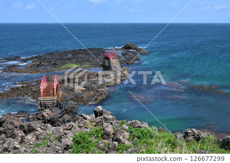 A scenic spot on the Tsugaru Peninsula: Shiosaibashi Bridge and Nagisabashi Bridge at Takanozaki. A rocky area with white waves caused by strong winds. A scenic spot on the Tsugaru Peninsula: Shiosaibashi Bridge and Nagisabashi Bridge at Takanozaki. A rocky area with white waves caused by strong winds. 126677299
