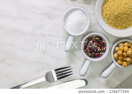 Ingredients and cutlery setting up a lunch on a marble table 126677304