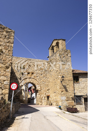 Medieval gate and bell tower dominating Calle La Virgen in Canete, Spain 126677350