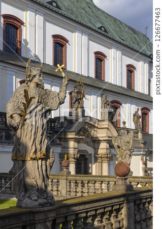 Statue of Saint holding cross in Broumov Monastery, Czechia 126677463