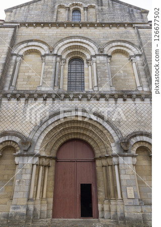 Church of Saint Hilaire le Grand showing its partially open red door in Poitiers, France Church of Saint Hilaire le Grand showing its partially open red door in Poitiers, France 126677502