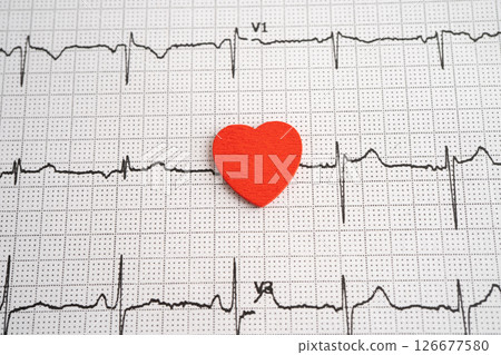 Red heart on electrocardiogram ECG with red heart, heart wave, heart attack, cardiogram report. Red heart on electrocardiogram ECG with red heart, heart wave, heart attack, cardiogram report. 126677580