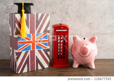 UK flag with graduate hat on english language book. UK flag with graduate hat on english language book. 126677585