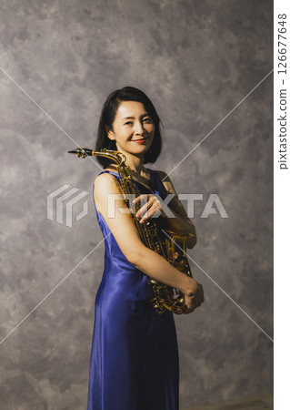 Portrait of a woman with a saxophone 126677648