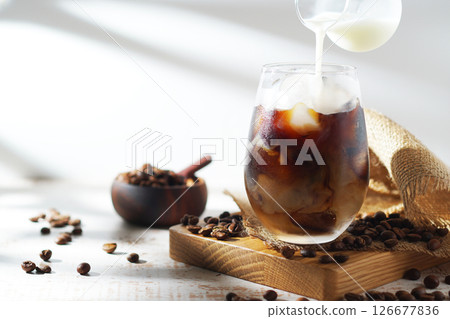 cold milk poured into iced coffee cold milk poured into iced coffee 126677836