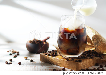 cold milk poured into iced coffee cold milk poured into iced coffee 126677874
