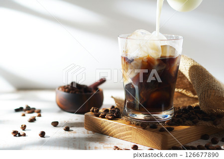 cold milk poured into iced coffee cold milk poured into iced coffee 126677890