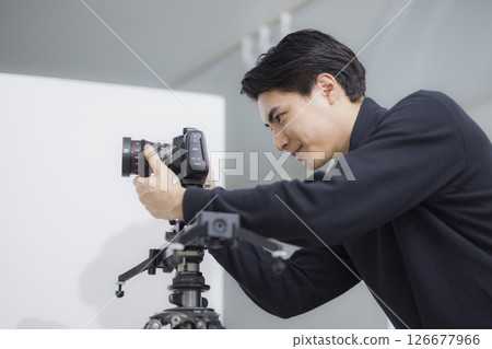Male cameraman taking a video Male cameraman taking a video 126677966