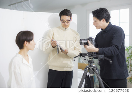 Male cameraman taking a video 126677968