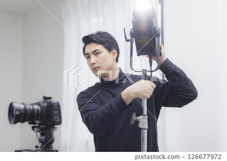 Male cameraman taking a video Male cameraman taking a video 126677972
