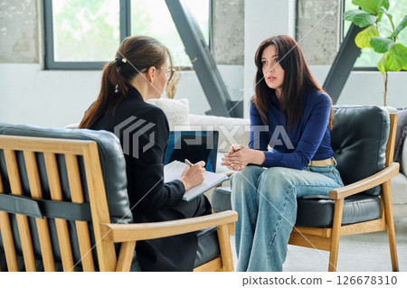 Young woman patient in mental therapy session, having professional help psychologist Young woman patient in mental therapy session, having professional help psychologist 126678310