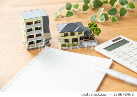 House model, calculator and notebook 126678408