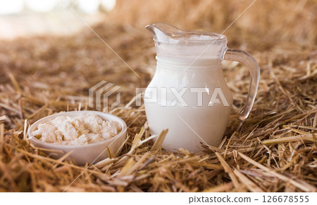 Jug of milk and cottage cheese in mow Jug of milk and cottage cheese in mow 126678555
