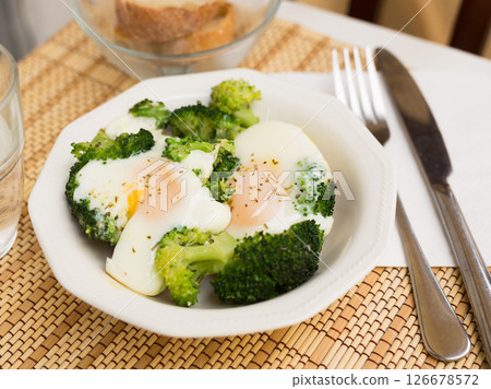 Breakfast of scrambled eggs with broccoli on the table Breakfast of scrambled eggs with broccoli on the table 126678572