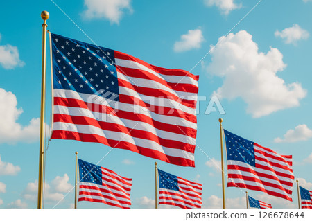 Large American flag waving on tall pole against blue sky with clouds, celebrating national holiday, freedom, patriotic pride, independence and unity for important events 126678644