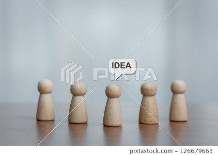 Five Wooden Figurines with Central Figure Highlighted by 'IDEA' Speech Bubble, Brainstorming Concept 126679663
