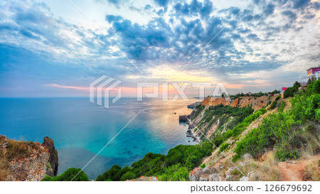 Unbelivable sunset at cape Fiolent with bushes grass and rocks at foreground. 126679692