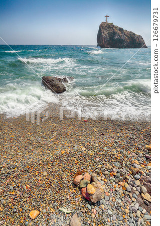 Amazing view of sea waves crashing on the shore and flowing above seashore pebbles Amazing view of sea waves crashing on the shore and flowing above seashore pebbles 126679731