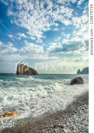 Amazing view of sea waves crashing on the shore and flowing above seashore pebbles. 126679739