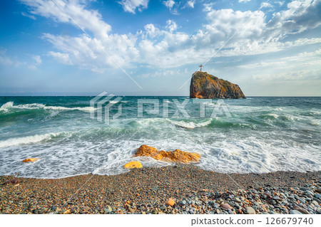 Amazing view of sea waves crashing on the shore and flowing above seashore pebbles. 126679740