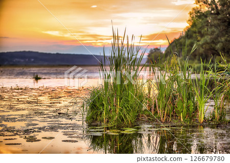 Beautiful sunset over calm lake. Beautiful sunset over calm lake. 126679780