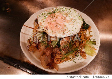 close up of Japanese Hiroshima style with pan fried egg, cabbage and noodles (Hiroshima Style Okonomiyaki) close up of Japanese Hiroshima style with pan fried egg, cabbage and noodles (Hiroshima Style Okonomiyaki) 126680273