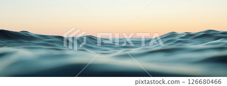 Gentle ocean waves creating mesmerizing ripples beneath a serene sunset sky, offering a tranquil and captivating glimpse into the beauty of nature's evening display 126680466