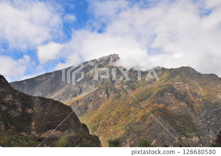 Photo of mountains shrouded in clouds and fog Photo of mountains shrouded in clouds and fog 126680580
