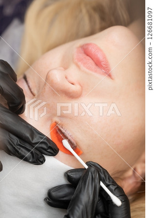 Caucasian woman undergoing eyelash lamination procedure.  126681097