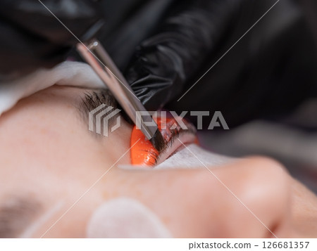 Caucasian woman undergoing eyelash lamination procedure. Caucasian woman undergoing eyelash lamination procedure. 126681357