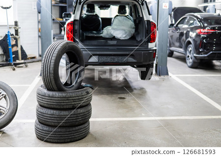 Changing tires for a car according to the season.  126681593