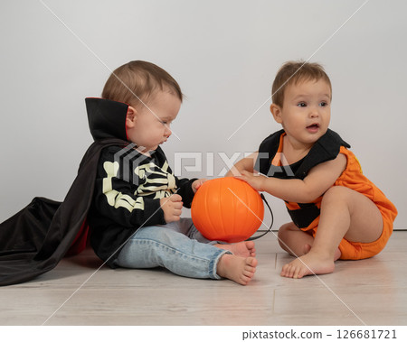 Cute kids celebrate halloween on white background. Two little boys in dracula costume and pumpkin. Cute kids celebrate halloween on white background. Two little boys in dracula costume and pumpkin. 126681721