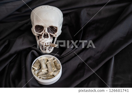 Skull Chewing Tobacco on Black Cloth.  126681741