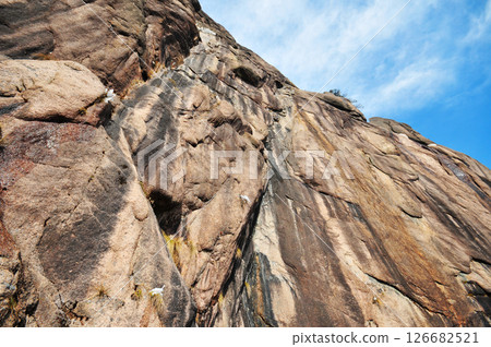 steep rock wall against blue sky background, China, Anhui Province, Mount Huang steep rock wall against blue sky background, China, Anhui Province, Mount Huang 126682521