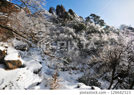 Mountain landscape after heavy snowfall, trees covered with snow and rime, China, Anhui Province, Mount Huang Mountain landscape after heavy snowfall, trees covered with snow and rime, China, Anhui Province, Mount Huang 126682523