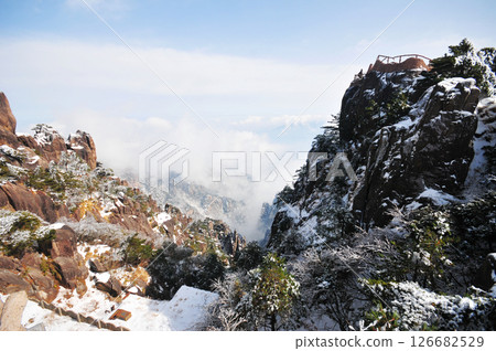 Mountain landscape after heavy snowfall, trees covered with snow and rime, sea of fluffy misty clouds ,China, Anhui Province, Mount Huang Mountain landscape after heavy snowfall, trees covered with snow and rime, sea of fluffy misty clouds ,China, Anhui Province, Mount Huang 126682529