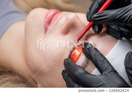 Caucasian woman undergoing eyelash lamination procedure.  126682624