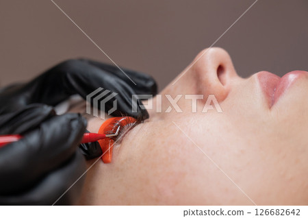 Caucasian woman undergoing eyelash lamination procedure.  126682642