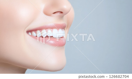 Close up of a smiling woman showcasing her healthy teeth and lips, emphasizing beauty and wellness, perfect for concepts related to dental hygiene and cosmetic care 126682704