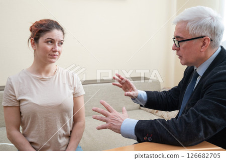Elderly male hypnotherapist with a female patient. An alternative way to heal mental health Elderly male hypnotherapist with a female patient. An alternative way to heal mental health 126682705