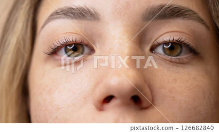 Close-up portrait of a woman after eyelash lamination procedure. Close-up portrait of a woman after eyelash lamination procedure. 126682840